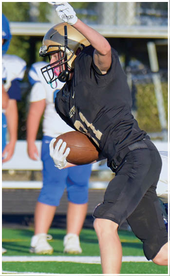 A football player running on the field. Description generated by AI