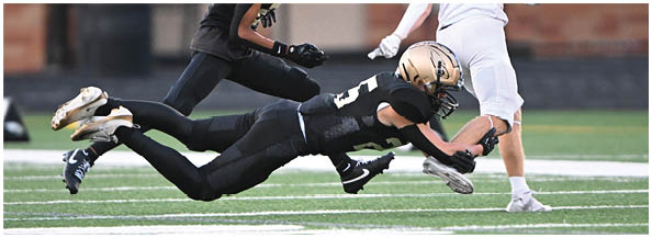 A football player is sliding on the ground. Description generated by AI
