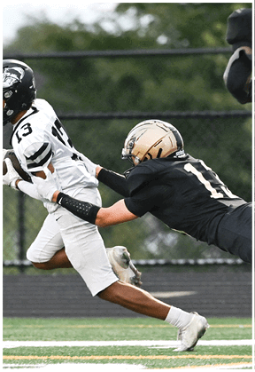 A football player running on the field. Description generated by AI