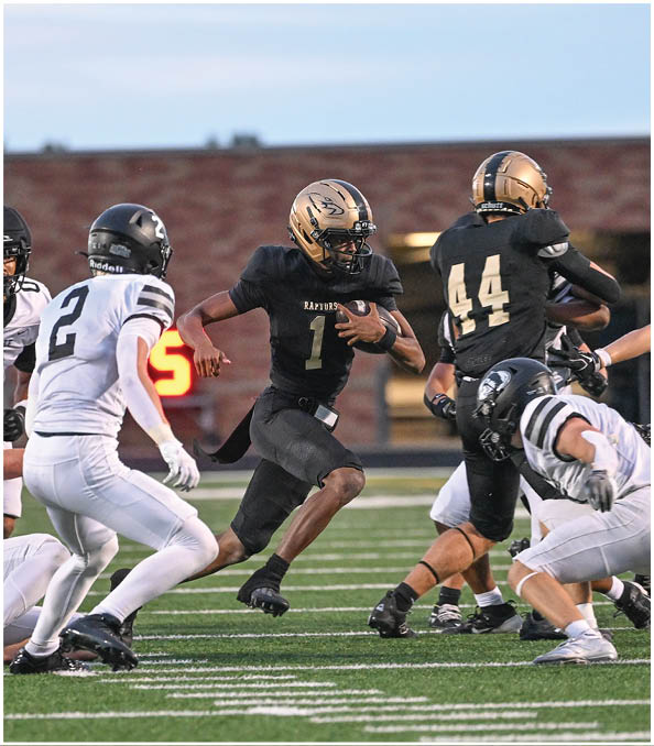 A group of football players wearing black and white uniforms. Description generated by AI