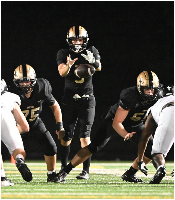 A group of football players wearing black and white uniforms. Description generated by AI