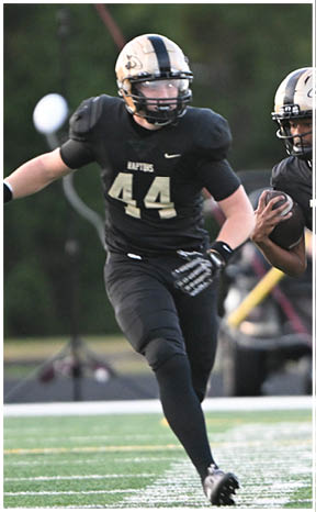 A football player running on the field. Description generated by AI