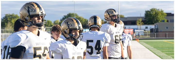 A group of football players on a field. Description generated by AI