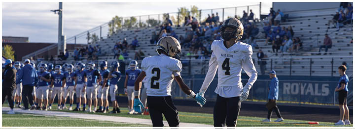 A football player is sliding on the ground. Description generated by AI