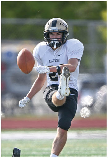 A football player running on the field. Description generated by AI