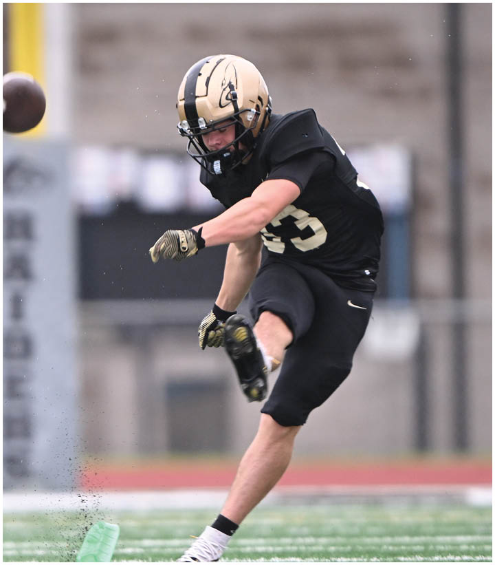 A group of football players wearing black and white uniforms. Description generated by AI
