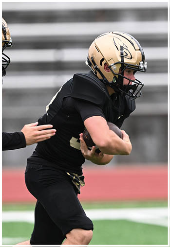 A football player running on the field. Description generated by AI