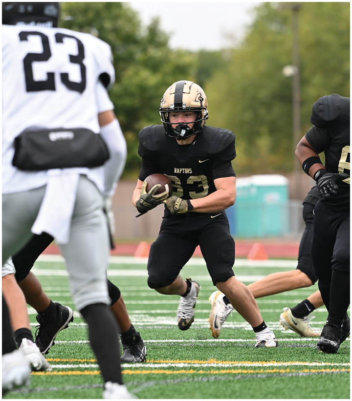 A group of football players wearing black and white uniforms. Description generated by AI