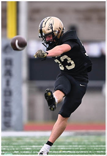 A football player running on the field. Description generated by AI