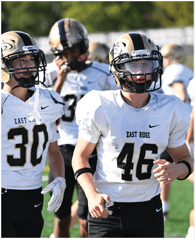 A group of football players wearing black and white uniforms. Description generated by AI