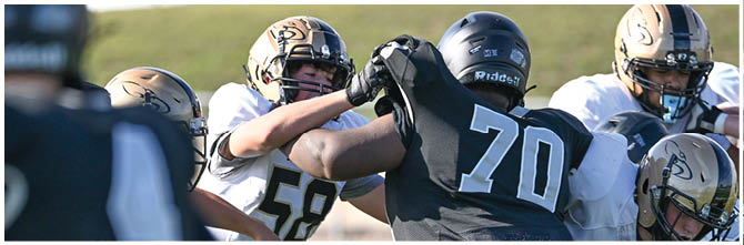 A football player is sliding on the ground. Description generated by AI