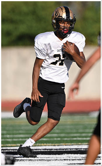 A football player running on the field. Description generated by AI