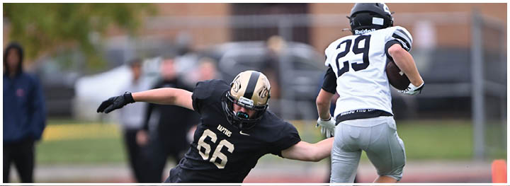 A football player is sliding on the ground. Description generated by AI
