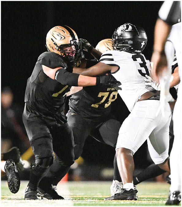 A group of football players wearing black and white uniforms. Description generated by AI