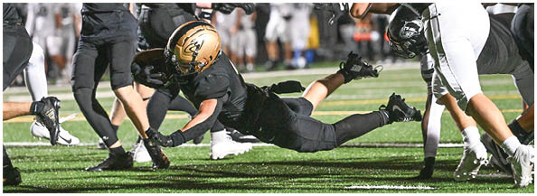 A football player is sliding on the ground. Description generated by AI