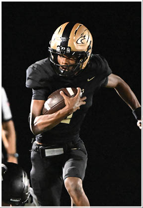 A football player running on the field. Description generated by AI