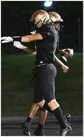 A football player running on the field. Description generated by AI