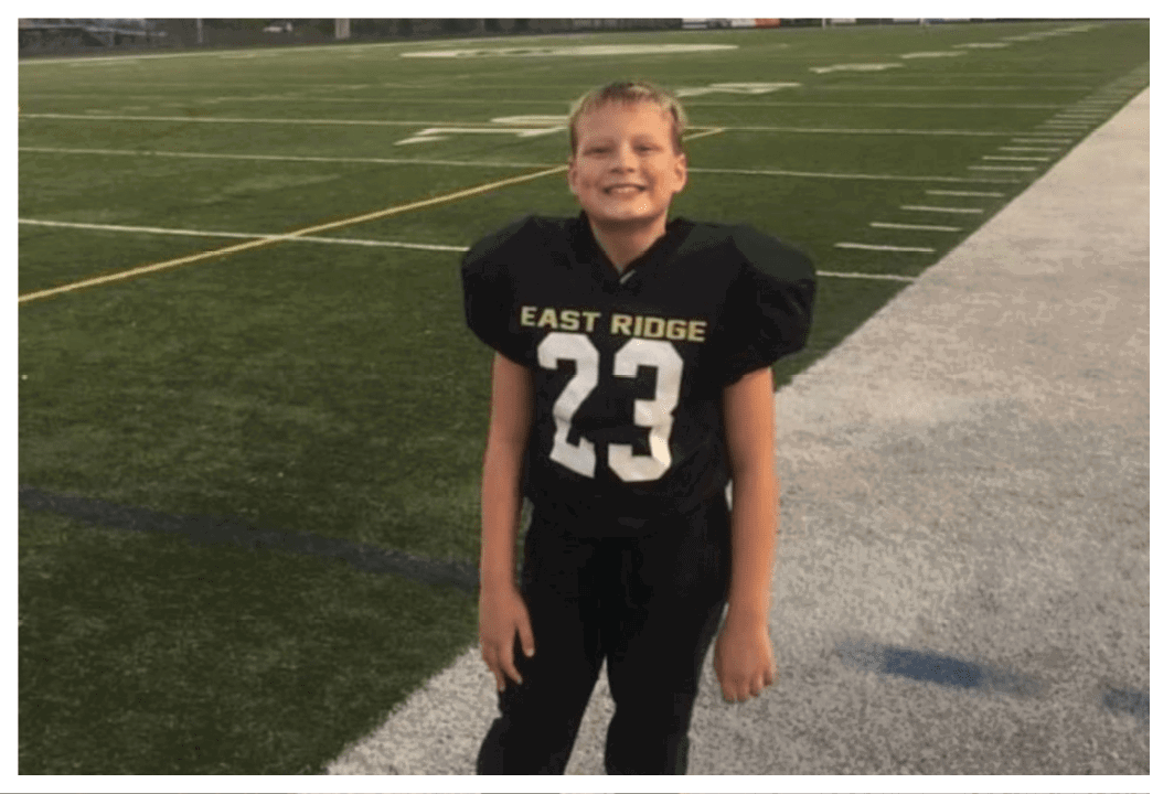 A football player wearing a blue and red jersey. Description generated by AI
