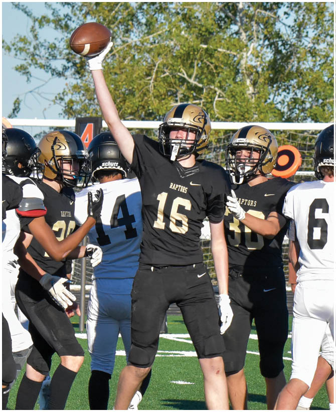 A group of football players wearing black and white uniforms. Description generated by AI