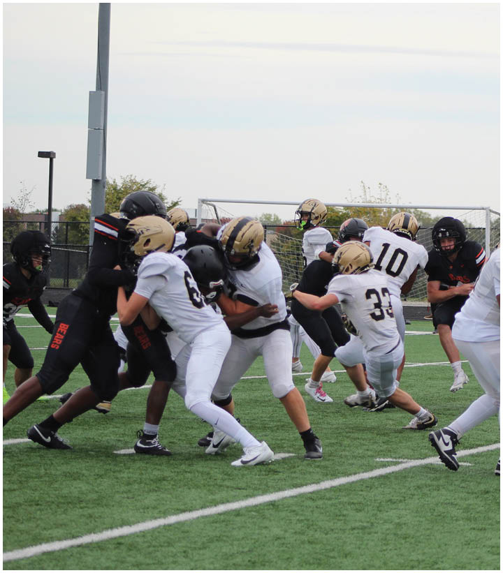A group of football players wearing black and white uniforms. Description generated by AI