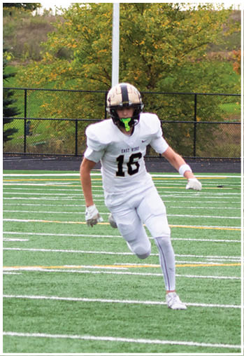 A football player running on the field. Description generated by AI
