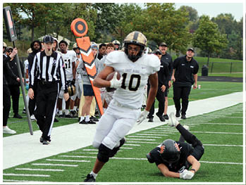 A football player running on the field. Description generated by AI