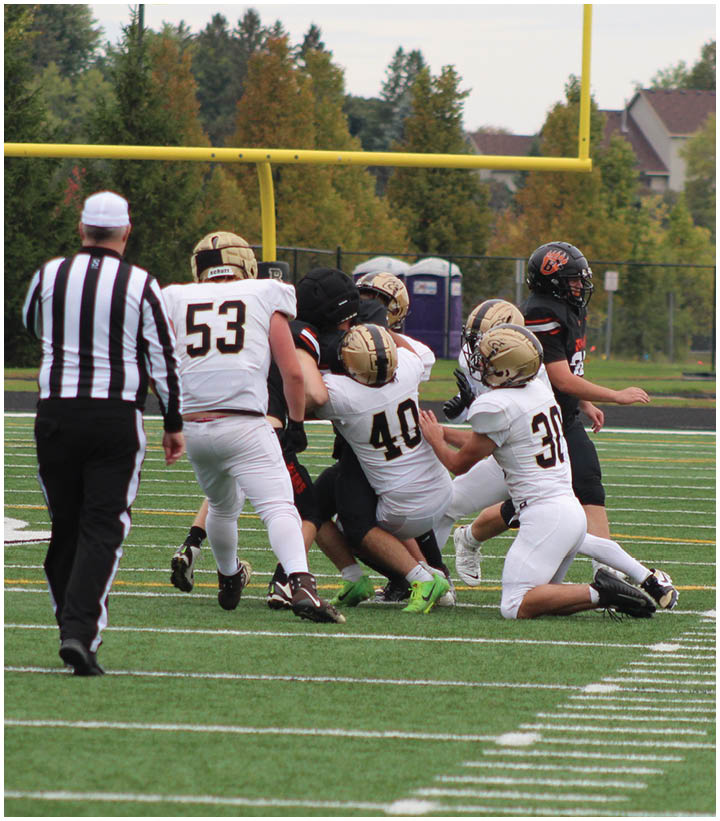 A group of football players wearing black and white uniforms. Description generated by AI