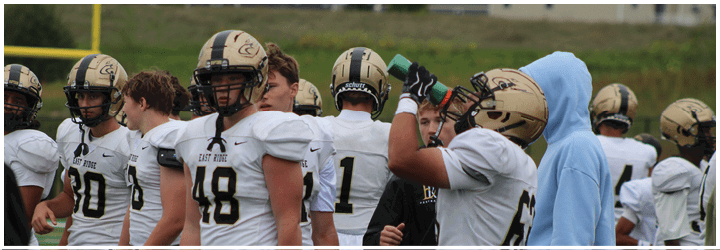 A group of football players on a field. Description generated by AI