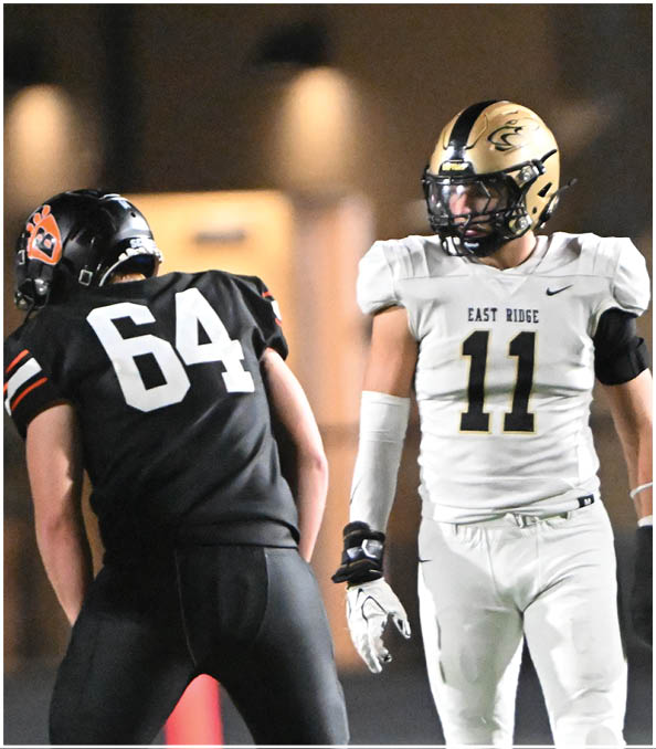 A group of football players wearing black and white uniforms. Description generated by AI