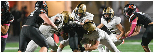 A group of football players on a field. Description generated by AI