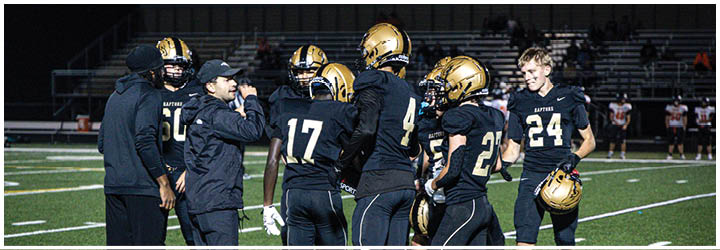 A group of football players on a field. Description generated by AI