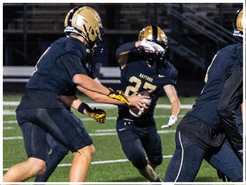 A football player running on the field. Description generated by AI
