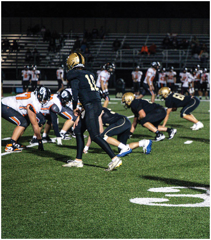 A group of football players wearing black and white uniforms. Description generated by AI