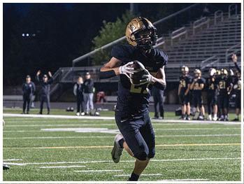 A football player running on the field. Description generated by AI