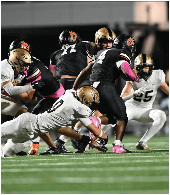 A group of football players wearing black and white uniforms. Description generated by AI