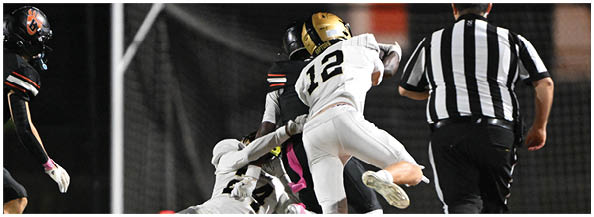 A football player is sliding on the ground. Description generated by AI