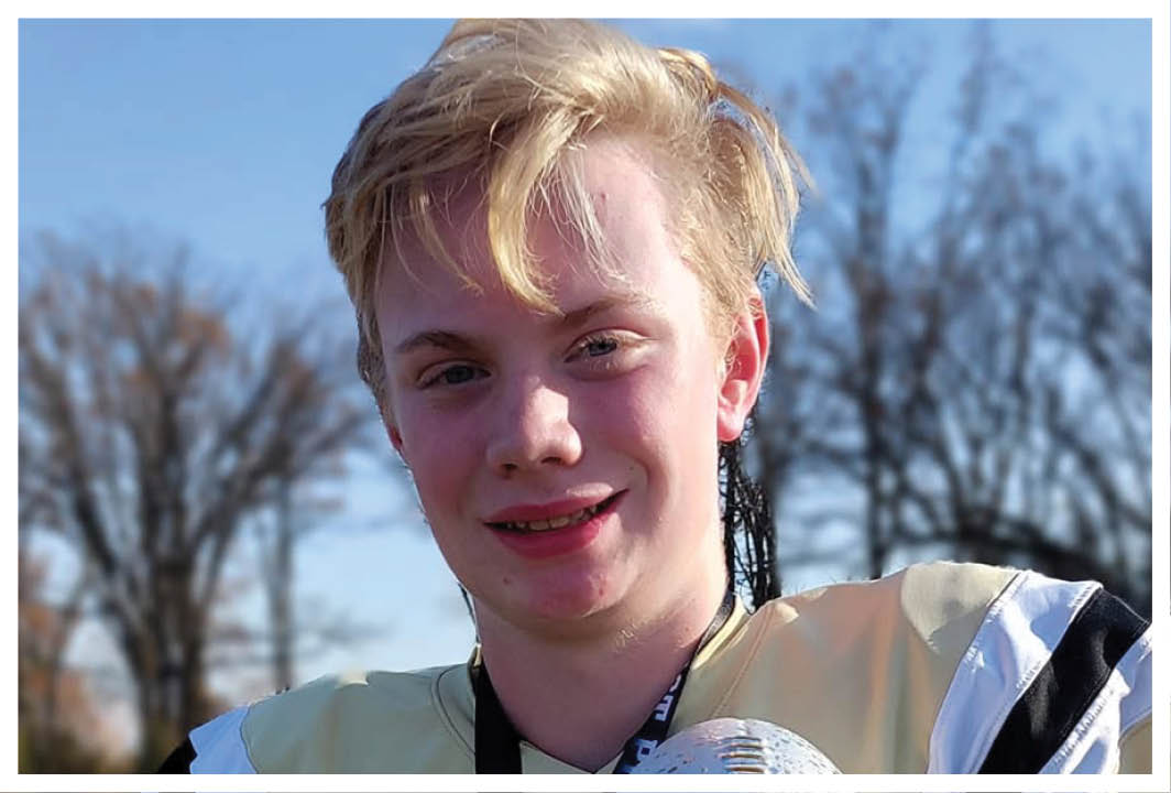 A football player wearing a blue and red jersey. Description generated by AI