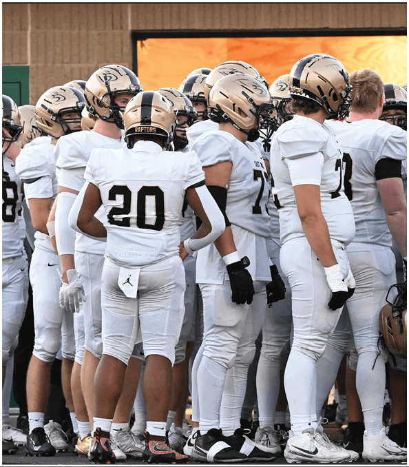 A group of football players wearing black and white uniforms. Description generated by AI
