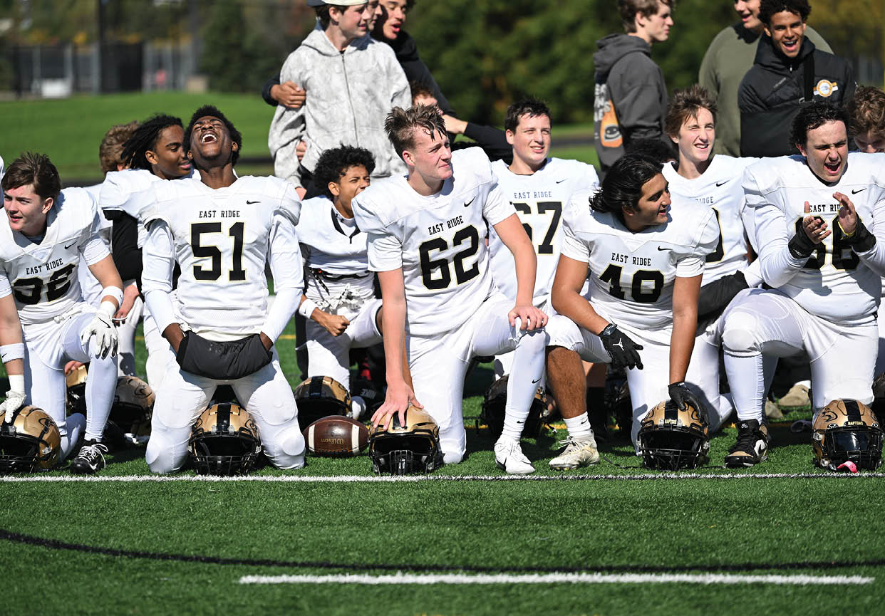 A group of football players wearing black and white uniforms. Description generated by AI