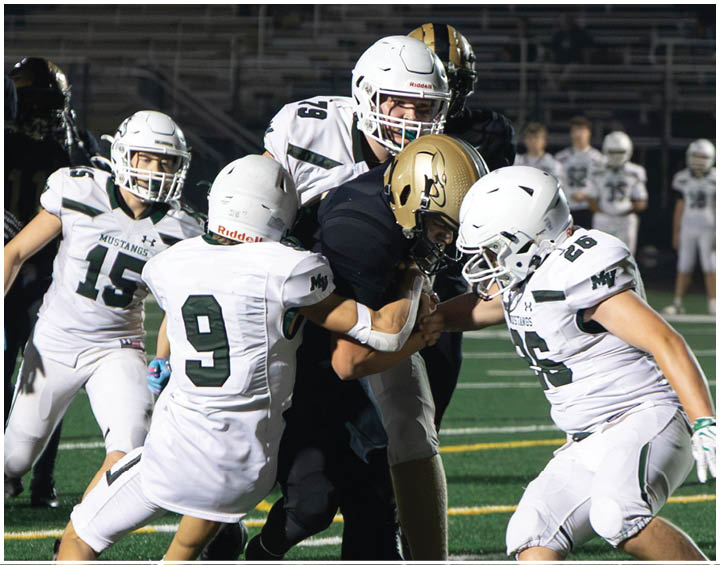 A group of football players wearing black and white uniforms. Description generated by AI