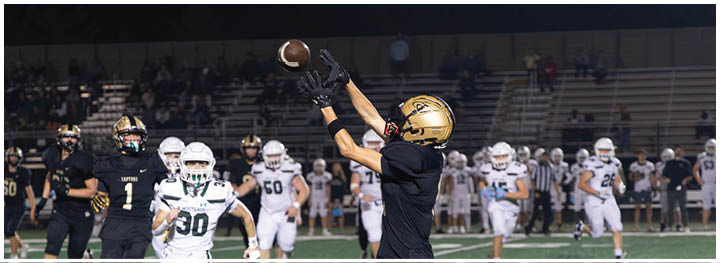 A football player is sliding on the ground. Description generated by AI