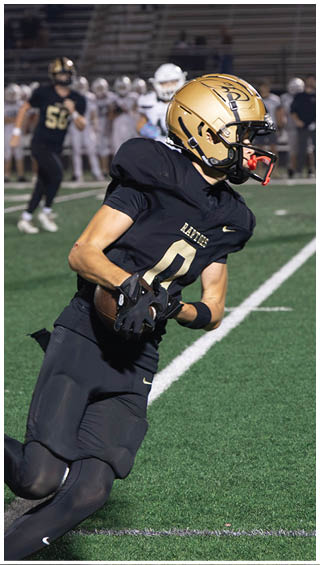 A football player running on the field. Description generated by AI