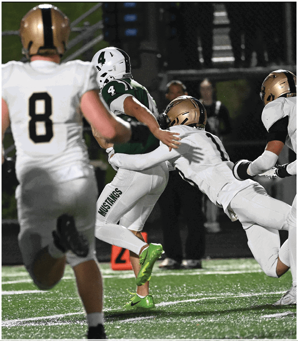 A group of football players wearing black and white uniforms. Description generated by AI