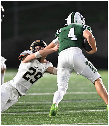 A football player running on the field. Description generated by AI
