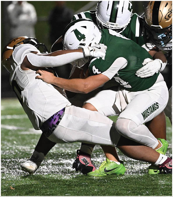 A group of football players wearing black and white uniforms. Description generated by AI