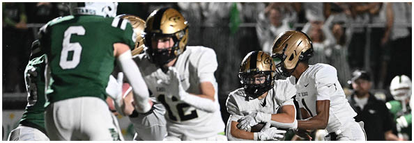 A group of football players on a field. Description generated by AI
