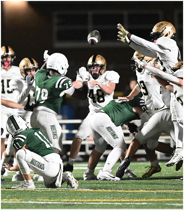 A group of football players wearing black and white uniforms. Description generated by AI