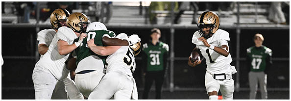 A group of football players on a field. Description generated by AI