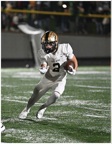 A football player running on the field. Description generated by AI
