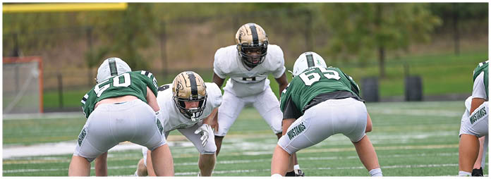 A football player is sliding on the ground. Description generated by AI